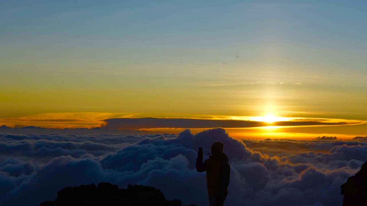 Mount Kilimanjaro at dawn above the clouds